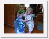 WaterJugBabies2 * The twins enjoyed playing with the big water jugs. They could even move them around!